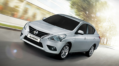 Silver Almera driving on the road